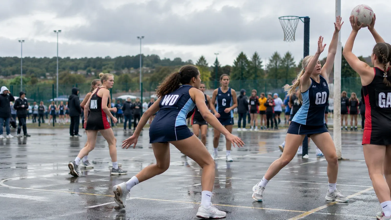 Young netball players moving into position during an outdoor community match