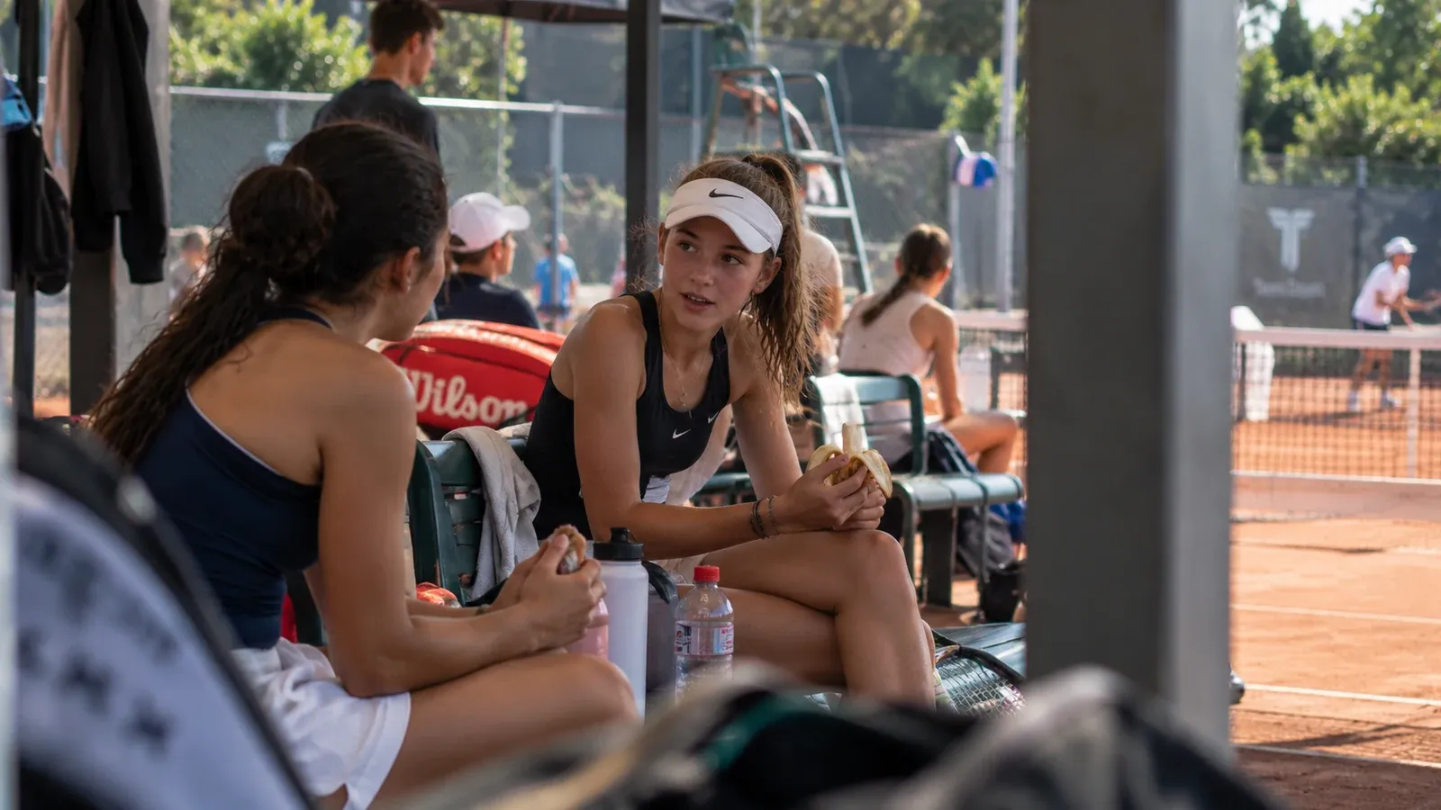 Young tennis player eating between competition matches